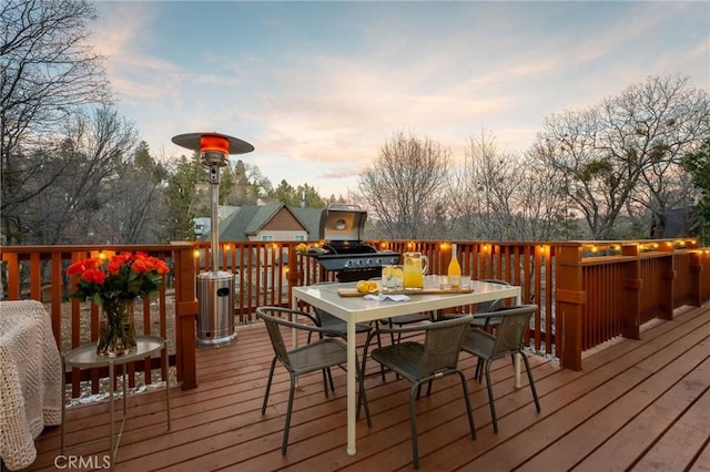 deck at dusk featuring grilling area