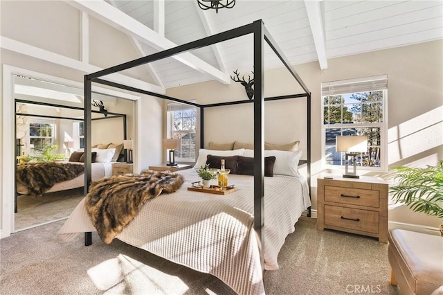 carpeted bedroom with beam ceiling, high vaulted ceiling, and multiple windows