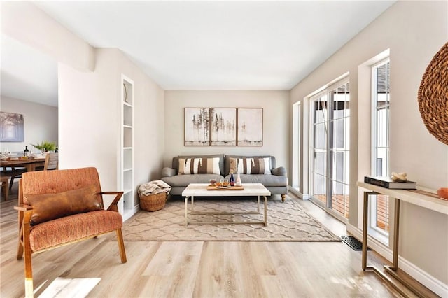 living area with light hardwood / wood-style flooring