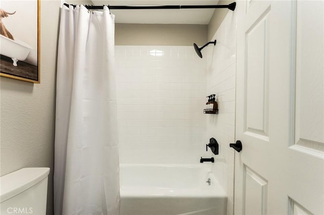 bathroom featuring toilet and shower / tub combo with curtain