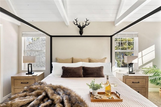 carpeted bedroom with lofted ceiling with beams and wooden ceiling