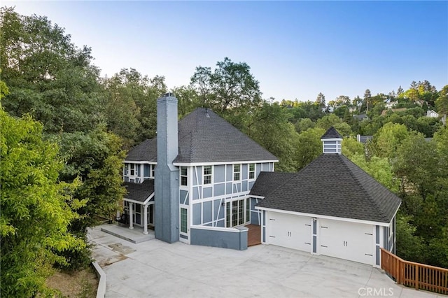 28164 N Bay Rd, Lake Arrowhead, CA 92352 - rear view of property with a chimney, roof with shingles, stucco siding, and a garage