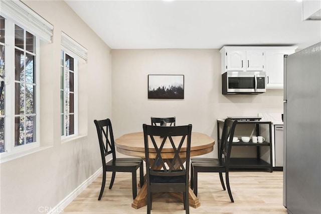 dining area with light hardwood / wood-style flooring