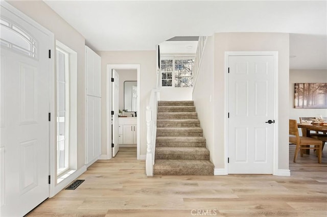 stairs with hardwood / wood-style floors