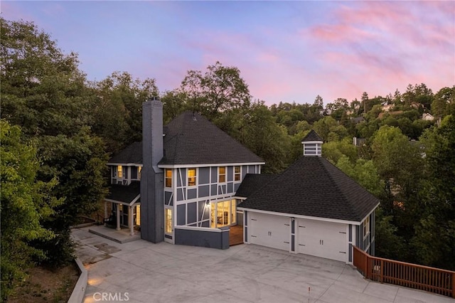 28164 N Bay Rd, Lake Arrowhead, CA 92352 - view of front facade featuring a chimney, a garage, concrete driveway, and a shingled roof