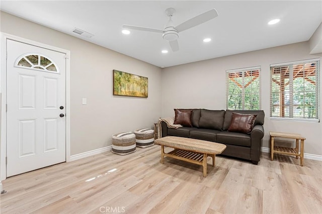 living room featuring light wood-type flooring and ceiling fan