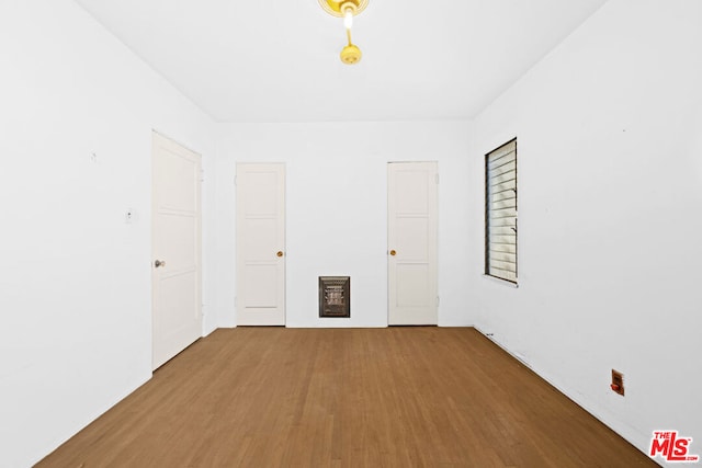 spare room with hardwood / wood-style floors