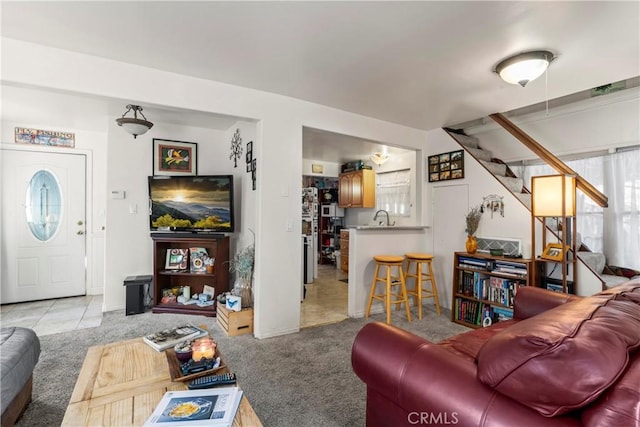 living room with sink and light colored carpet