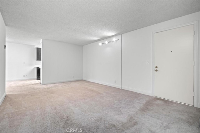 interior space with a textured ceiling and carpet floors