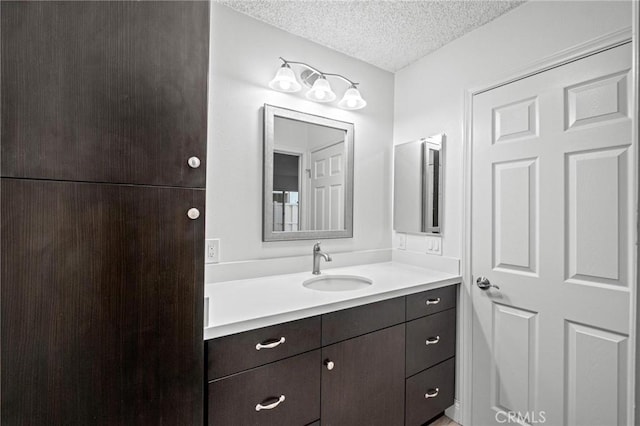 bathroom featuring vanity and a textured ceiling