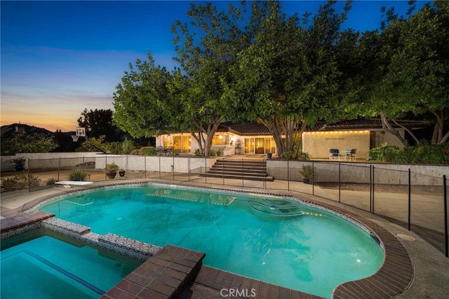 view of pool at dusk