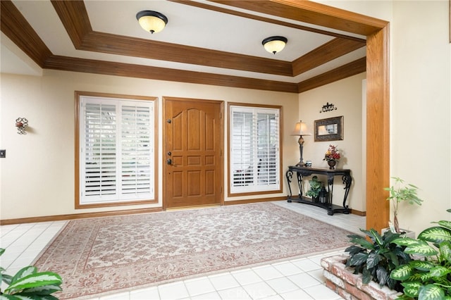 tiled entryway featuring a tray ceiling, crown molding, and a healthy amount of sunlight