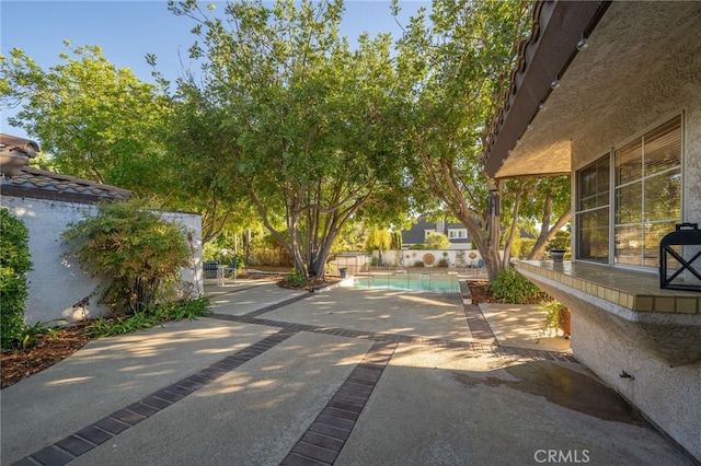 view of patio / terrace with a fenced in pool