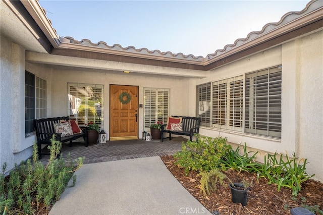 view of exterior entry with a porch