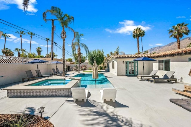 view of swimming pool with a patio area and an in ground hot tub