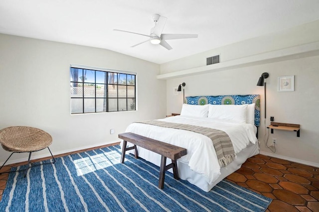 tiled bedroom featuring ceiling fan and lofted ceiling