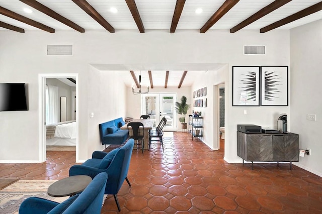 tiled living room featuring french doors and vaulted ceiling with beams