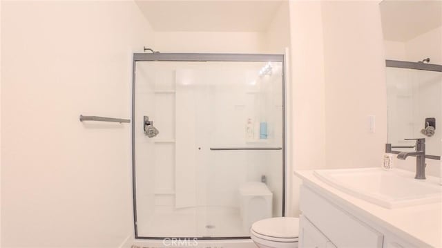 bathroom featuring vanity, toilet, and walk in shower