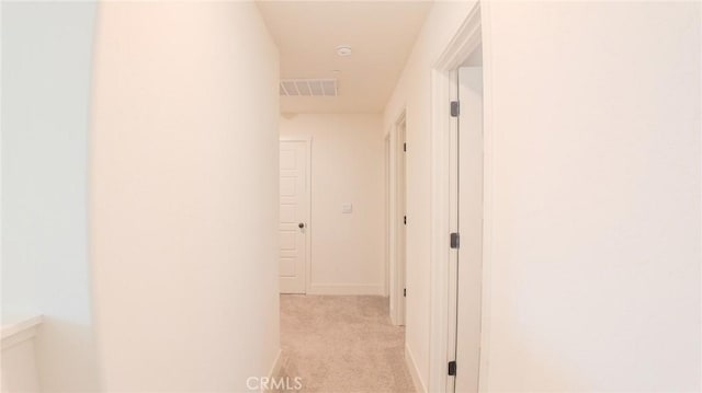 hall with light colored carpet