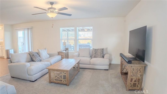 carpeted living room featuring ceiling fan