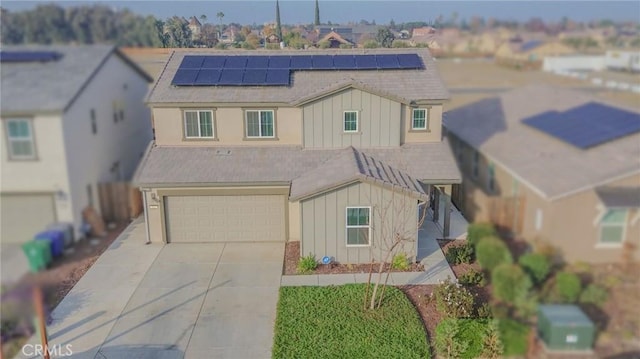 view of front of property with a garage and solar panels