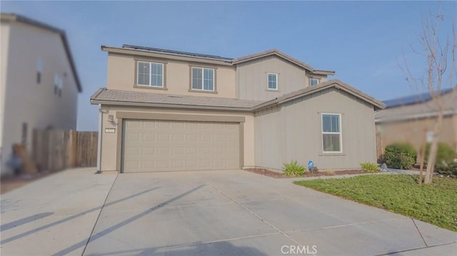 view of property featuring a front lawn and a garage