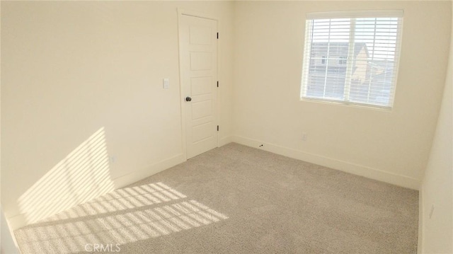 unfurnished room featuring light carpet