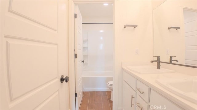 full bathroom with vanity, washtub / shower combination, and toilet