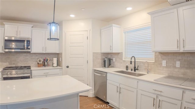 kitchen with white cabinetry, sink, and appliances with stainless steel finishes