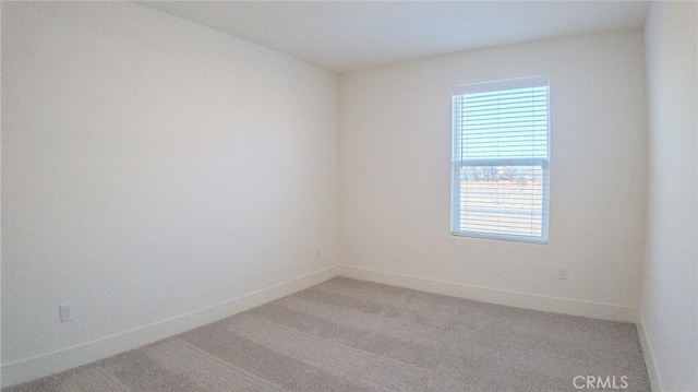 unfurnished room with light colored carpet