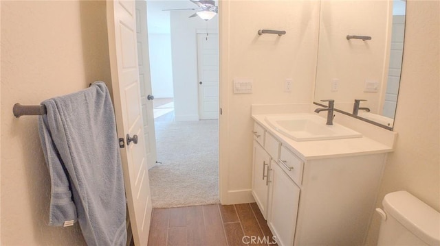 bathroom with vanity, ceiling fan, and toilet