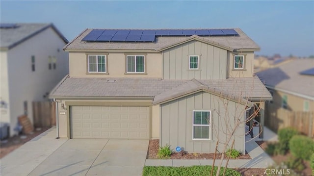 view of front of home featuring a garage and solar panels