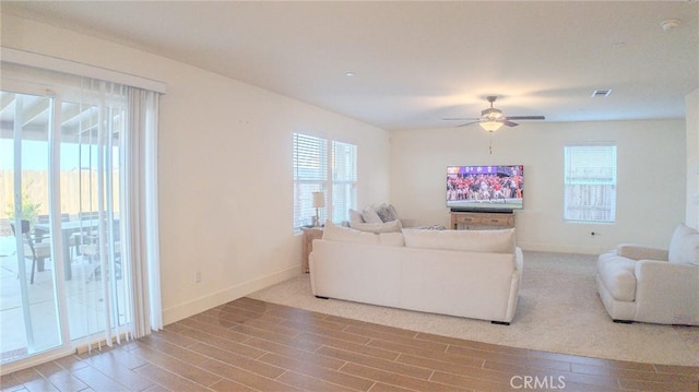 living room featuring hardwood / wood-style flooring and ceiling fan