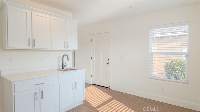 kitchen with white cabinetry and sink