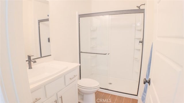 bathroom featuring hardwood / wood-style flooring, vanity, toilet, and a shower with shower door