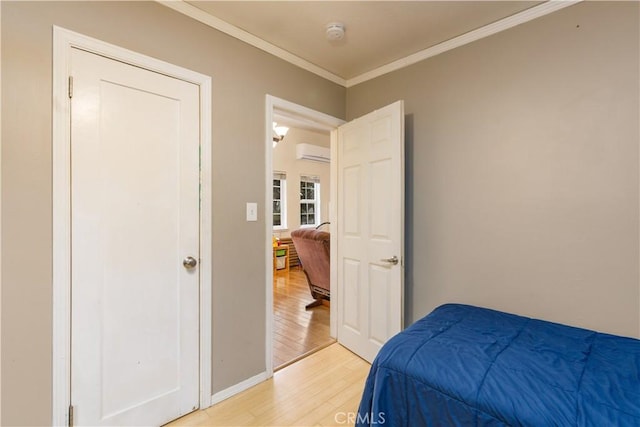 9528 Washington St, Upper Lake, CA 95485 - bedroom featuring baseboards, light wood finished floors, crown molding, and a wall unit AC