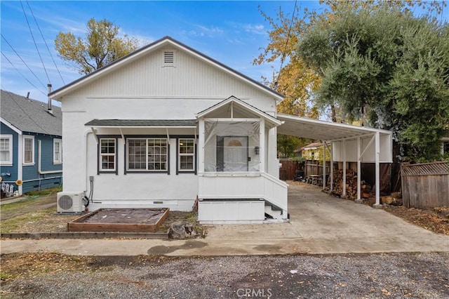 view of front of home with ac unit and a carport