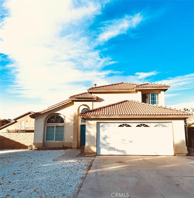 mediterranean / spanish-style house with a garage