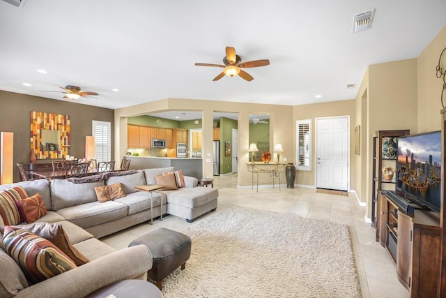 tiled living room featuring ceiling fan