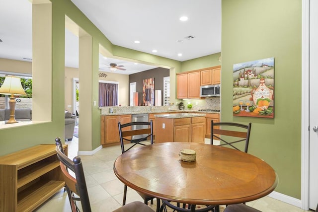 dining room with ceiling fan and light tile patterned floors