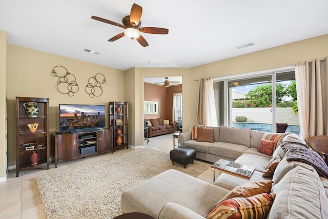 living room with ceiling fan and light tile patterned floors