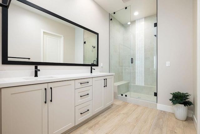 bathroom featuring vanity, hardwood / wood-style floors, and walk in shower