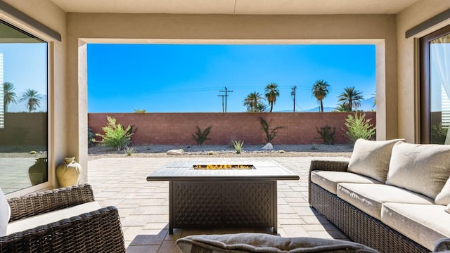 view of patio / terrace with an outdoor living space with a fire pit