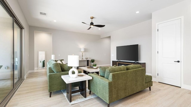 living room featuring ceiling fan and light wood-type flooring