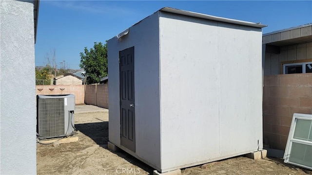 view of property exterior featuring a shed and cooling unit