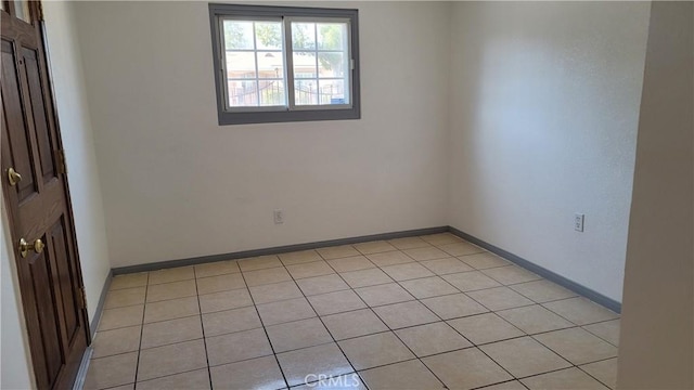 unfurnished room with light tile patterned floors