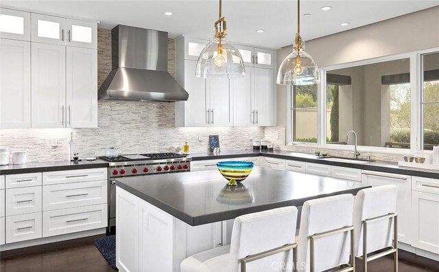 51 Monarch Beach Resort S, Dana Point, CA 92629 - kitchen featuring wall chimney range hood, luxury range, dark countertops, and recessed lighting