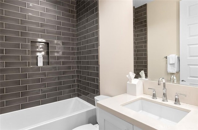 full bathroom with vanity, toilet, and tiled shower / bath combo