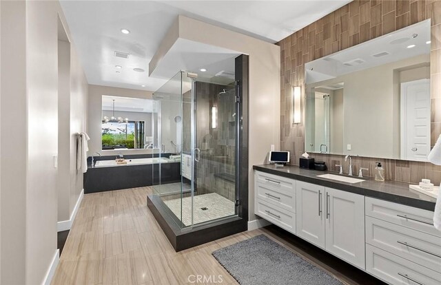51 Monarch Beach Resort S, Dana Point, CA 92629 - full bath with vanity, a stall shower, a garden tub, a chandelier, and recessed lighting