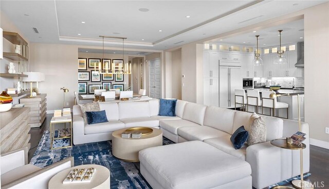 51 Monarch Beach Resort S, Dana Point, CA 92629 - living room with a tray ceiling, dark wood-type flooring, recessed lighting, and a chandelier